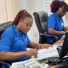 An assistant working beside a manager