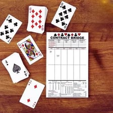Playing cards in a bridge game showing a trump play