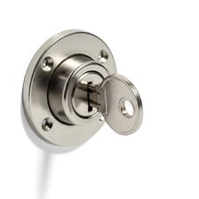 A metal key inserted into a lock.