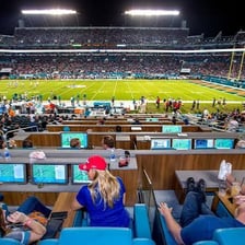 A football stadium filled with spectators seated in every stand