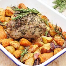 A cooked leg of lamb on a serving platter