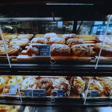 Assorted freshly baked pastries displayed in a bakery
