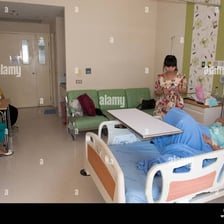 A patient lying in a hospital ward.