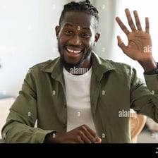 A person raising a hand in greeting.