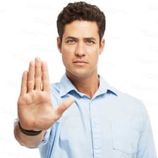 A person warning someone else with an urgent hand gesture.