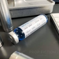 A medicine vial representing an antidote.