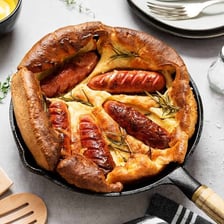 A traditional toad in the hole made with sausages baked in Yorkshire pudding batter.
