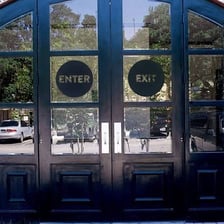 An entrance doorway with a sign indicating the center
