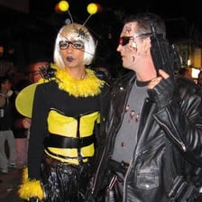 People wearing colourful fancy-dress costumes at a party
