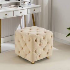 A small upholstered footstool.
