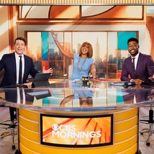 A presenter delivering a broadcast in a television studio.