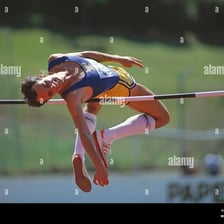 An athlete arching over the bar in a high-jump competition.