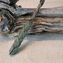 A slender wand-like rod associated with magic and spell-casting.