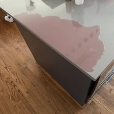 Beer spilled across a counter, creating a visibly slippery surface.