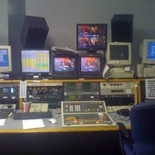 A television broadcasting control room with monitors and equipment.