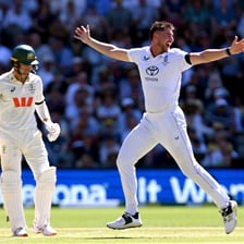 A cricket batsman playing a shot that has edged the ball toward the wicket.