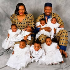 A family photograph featuring eight babies.