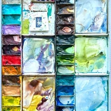 Paint being mixed on an artist’s palette
