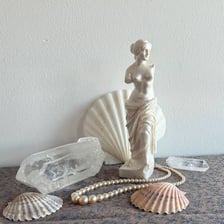 A pale translucent alabaster ornament with carved decoration.