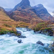 A fast-flowing mountain river swollen by heavy water flow