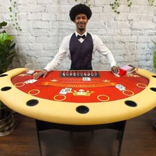 A casino dealer dealing cards at a blackjack table