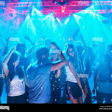 People dancing under lights in a disco