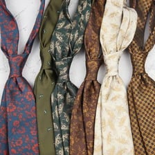 A traditional striped school tie worn around a shirt collar