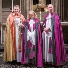 A church canon in clerical dress inside a cathedral.