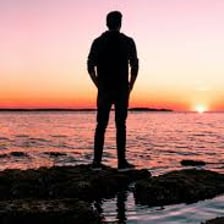 A person standing alone, representing being unattached.