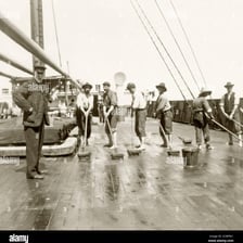 A ship’s crew preparing and clearing the deck.