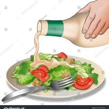 Sauce being poured over a plated dish