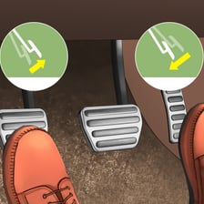 A driver changing gear with a car’s manual gear lever