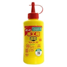 A bottle of glue beside two bonded pieces of wood.