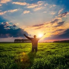 A cheerful person standing in bright sunlight.