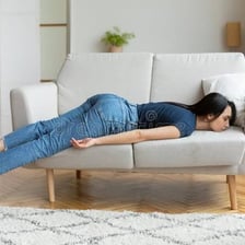 An exhausted person resting indoors.