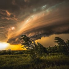 Smoke being blown across a landscape by wind
