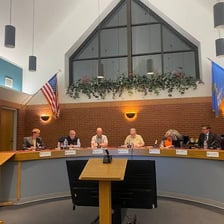 People seated at a meeting of a governing council