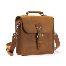 A leather satchel with a flap and shoulder strap