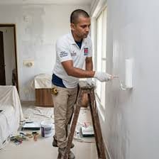 A painter applying a finishing coat of paint to a surface
