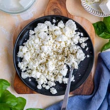 Crumbly white feta cheese in a dish