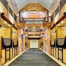 The interior of a stable with horse stalls
