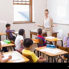 A teacher giving a lesson to a classroom.
