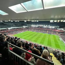 A spectator watching an event from stadium seating