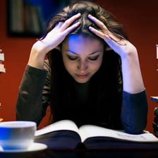 A student studying intensely from books.