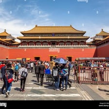 A large Chinese palace building with visitors