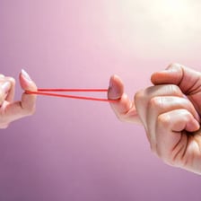 Elastic band stretched between two hands