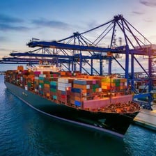Cargo containers at a port, representing international trade.