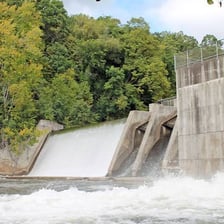 Water flowing over a weir in a river.