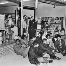 People seated together during a peaceful protest sit-in.