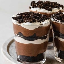 A layered parfait dessert served in a glass